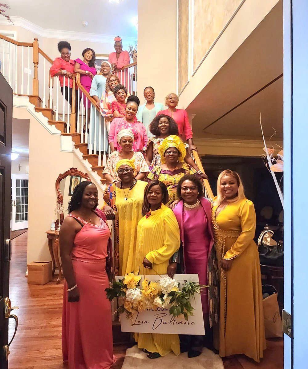 LESANs in formal gowns gathered on a staircase